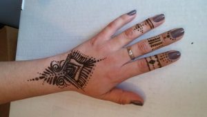 Black jagua tattoo design on hand