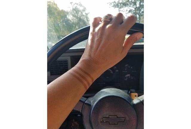 Driving in a Chevy with henna tattoo